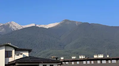 a view of a mountain range with houses and mountains at Bansko Royal Towers Thea Apartment, modern renovated bathroom in Bansko