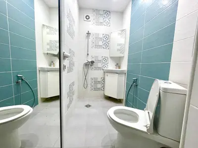 a bathroom with a toilet and a sink and a shower at Dreamy Apartment Near To The Center in Sofia