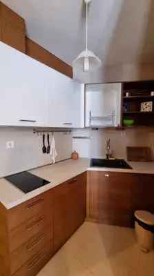a kitchen with wooden cabinets and a sink at BH & Semiramida Ski Apartment in Borovets