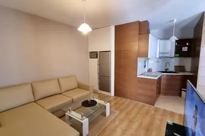 a living room with a couch and a kitchen at BH & Semiramida Ski Apartment in Borovets