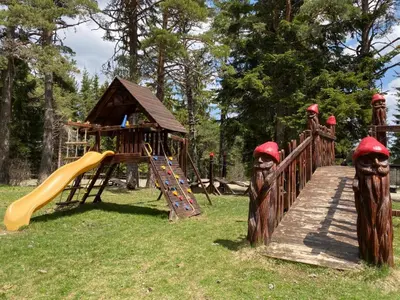 a playground with a wooden bridge and a slide at BH & Semiramida Ski Apartment in Borovets