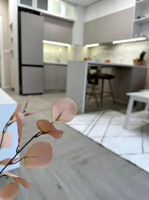 a room with a kitchen with a table and a counter at Мoka Apartment in Sofia