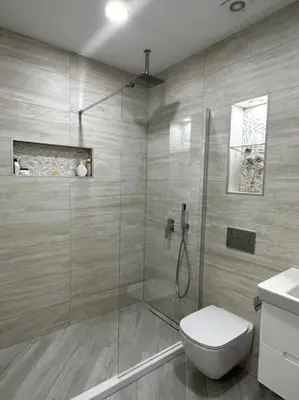 a bathroom with a shower with a toilet and a sink at Мoka Apartment in Sofia