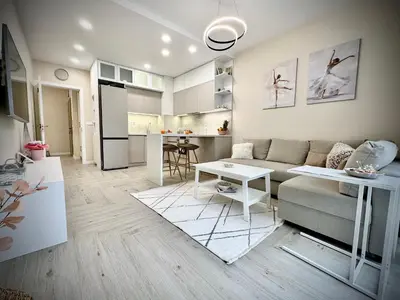 a living room with a couch and a table at Мoka Apartment in Sofia