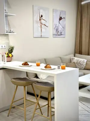a living room with a table with two plates of food at Мoka Apartment in Sofia