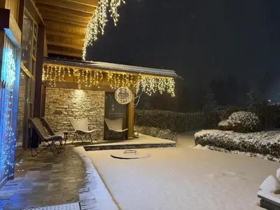 a patio with christmas lights on a house at Villa - VALL DI VALL in Pirin Golf & Country Club in Razlog