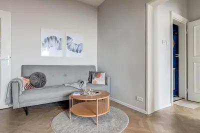 a living room with a couch and a table at Sofia's Elegant Urban Retreat in Sofia