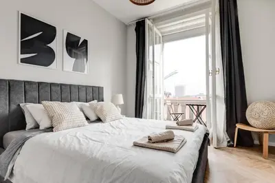 a bedroom with a large bed with two towels on it at Sofia's Elegant Urban Retreat in Sofia