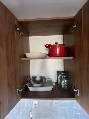 a kitchen with a shelf with some bowls and a pot at Lucky7Lux1 in Pazardzhik