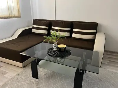 a living room with a couch and a glass table at Lucky7Lux1 in Pazardzhik