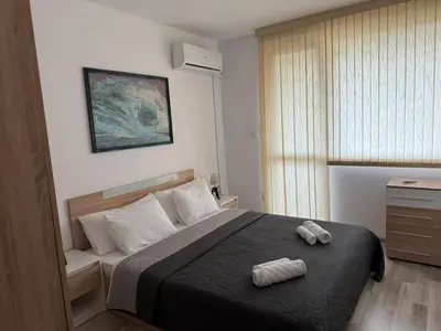 a bedroom with a bed with two towels on it at Lucky7Lux1 in Pazardzhik