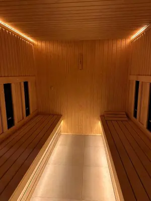 a sauna with two benches in a wooden room at Sana Ski apartment 702 in Flora, Borovets in Borovets