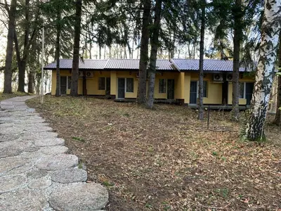 a yellow house with a path in front of it at Мотел Тихия кът in Sofia