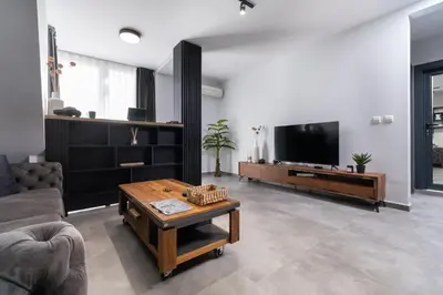 a living room with a couch and a tv at Chic 1BR Apartment with Balcony in Plovdiv in Plovdiv