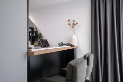 a desk with a laptop and a chair in a room at Chic 1BR Apartment with Balcony in Plovdiv in Plovdiv