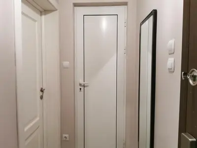 a white door in a bathroom with a mirror at Beautifully Decorated Functional Apartment in Sofia