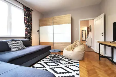 a living room with a couch and a chair at Beautifully Decorated Functional Apartment in Sofia