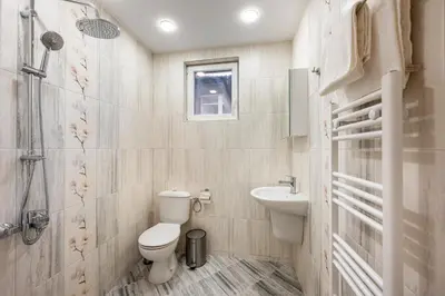 a bathroom with a toilet and a sink at Къща за гости Оскови in Velingrad
