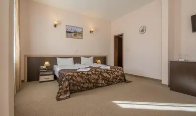 a hotel room with a bed and a television at Hotel Royal Borovets in Borovets