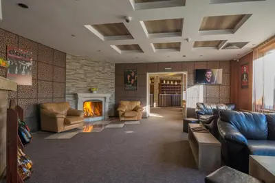 a living room with couches and a fireplace at Hotel Royal Borovets in Borovets