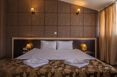 a bedroom with a bed with two towels on it at Hotel Royal Borovets in Borovets