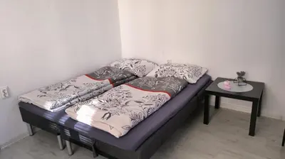 a bed with pillows on it in a room at Tea House Samokov in Samokov
