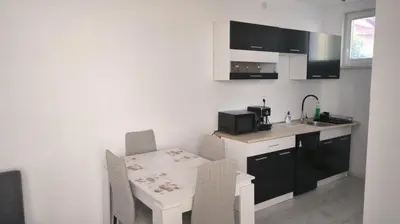 a kitchen with a table and chairs and a sink at Tea House Samokov in Samokov