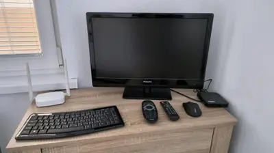 a computer monitor with a keyboard and mouse on a desk at Tea House Samokov in Samokov