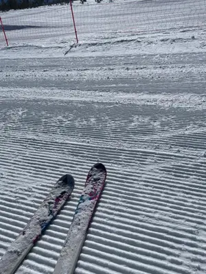 a pair of skis sitting in the snow at Spacious penthouse chalet apartment in Pirin Golf and Country Club in Razlog