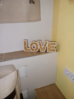 a shelf with a sign that says love on it at Top Center Studio 5 in Sofia