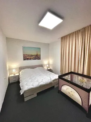 a bedroom with a large bed and a window at 2 Bedroom Apartment with Garage in Sandanski