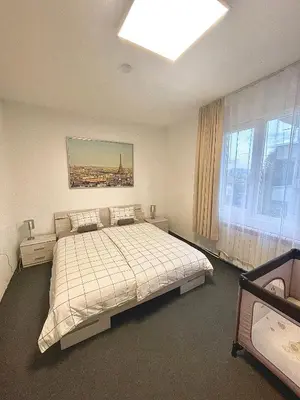 a bedroom with a large bed and a window at 2 Bedroom Apartment with Garage in Sandanski