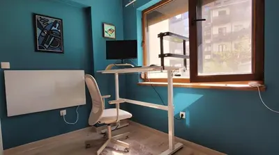a room with a desk and a chair and a window at Large Stylish 2-bedroom apt near ski road, 5 min to Gondola & Bar Street in Bansko
