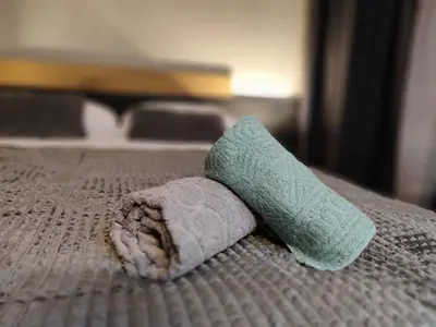 a green towel sitting on top of a bed at View apartment #2 in Bansko