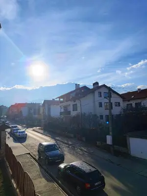 a group of cars parked on a street with buildings at View apartment #2 in Bansko