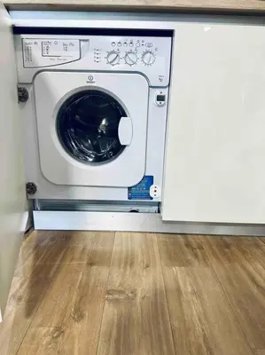 a washing machine in a room with a wooden floor at Modern Turquoise Apartment/free WiFi in Sofia