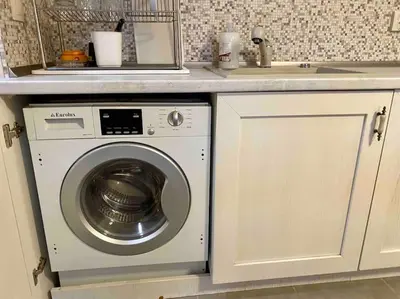 a washing machine under a counter in a kitchen at Stylish Magenta Apartment - terrace & free parking in Sofia