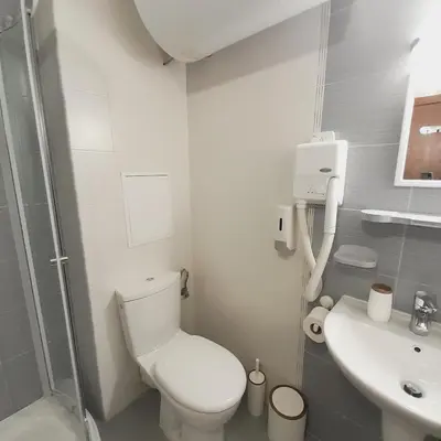 a small bathroom with a toilet and a sink at VIP Apartments Belvedere with terrace K105 in Bansko