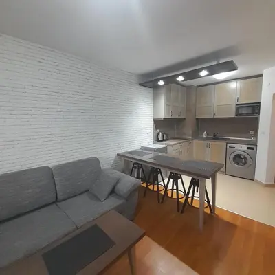 a living room with a couch and a table at VIP Apartments Belvedere with terrace K105 in Bansko