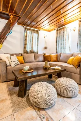 a living room with a couch and a table at Slona, Heritage Home in Old Town Plovdiv in Plovdiv