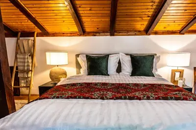 a bedroom with a large bed with two lamps at Slona, Heritage Home in Old Town Plovdiv in Plovdiv