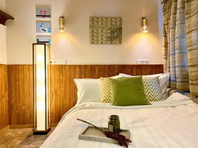 a bedroom with a bed with a table on it at Slona, Heritage Home in Old Town Plovdiv in Plovdiv