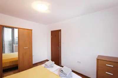 a bedroom with a mirror and a bed and a dresser at Ski Lift Apartment - Complex Gramadeto Bansko in Bansko