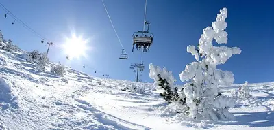a snow covered ski slope with a ski lift at Ski Lift Apartment - Complex Gramadeto Bansko in Bansko