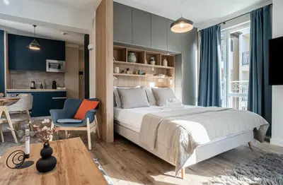a bedroom with a large bed and a dining room at 8th Hill Apartments in Plovdiv