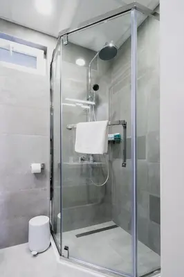 a shower with a glass door in a bathroom at 8th Hill Apartments in Plovdiv