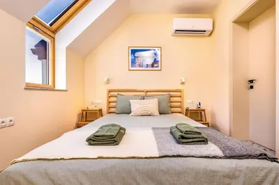 a bedroom with a bed with two towels on it at Hills View Central Apartment in Plovdiv