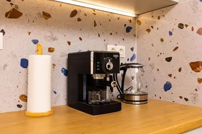 a coffee maker on a counter next to a paper towel at Hills View Central Apartment in Plovdiv
