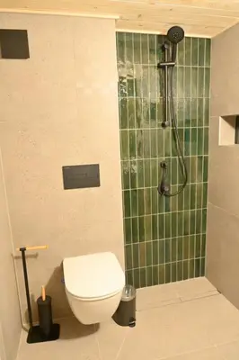 a bathroom with a toilet and a shower at Marand Boutique Apartments in Bansko