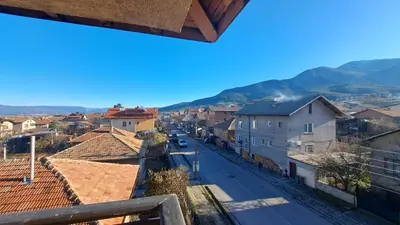 a view of a town with mountains in the background at REAL Guest House in Bansko